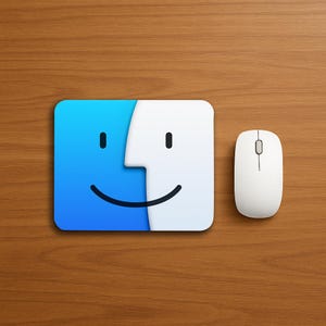 May include: A white computer mouse next to a blue and white square with a smiling face design. The square has a blue left side and a white right side. The background is a wood grain pattern.