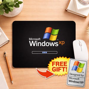 May include: Black rectangular mousepad featuring the Microsoft Windows XP logo in white and the Windows XP loading bar. A white mouse and a "Free Gift" sticker are also visible.