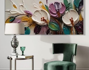 May include: A large, rectangular floral painting with thick, textured brushstrokes. The artwork features white and purple flowers with green leaves against a neutral background. A silver lamp, green glass, and a green velvet chair are in the foreground.