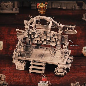 May include: A detailed, gray miniature tavern stage with a quest board, wooden planks, and a small staircase. The stage is adorned with various props, including a treasure chest, barrels, and a small backpack. The text "Hero's Path Tavern" is visible.