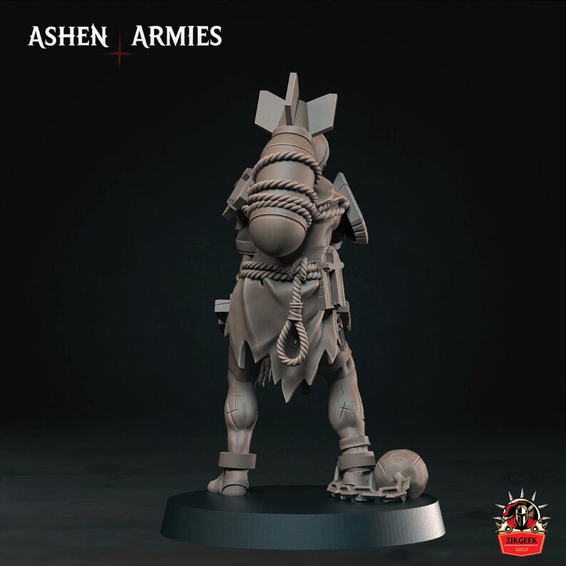 May include: A gray miniature figurine of a humanoid character standing on a circular base. The figure wears tattered clothing, carries a large bomb strapped to its back with rope, and has a ball and chain attached to one ankle. Text reads ASHEN ARMIES.