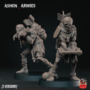 Może przedstawiać: Dwie szare miniaturowe figurki z Ashen Armies, każda z dużą bombą na plecach. Jedna postać ma ludzką twarz, a druga nosi gładką, okrągłą maskę z otworami na oczy. Obie figurki stoją na okrągłych podstawkach.