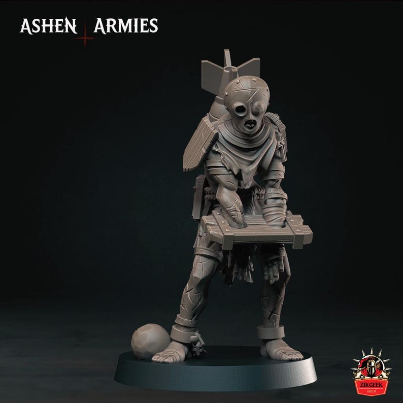 May include: A gray miniature figure from Ashen Armies featuring a character with a mask, a bomb strapped to its back, and holding a wooden crate. The figure has shackles on its ankles and stands on a circular base with a small ball nearby.