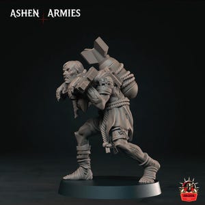 May include: A grey miniature figurine titled ASHEN ARMIES depicting a figure carrying a large bomb on their back with rope bindings. The figure wears tattered clothing, leg wraps, and has visible scars. The base is circular and black.