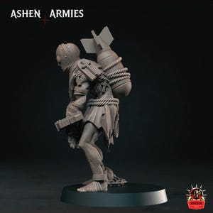 May include: A grey miniature figure from Ashen Armies featuring a helmeted character carrying a large bomb strapped to its back with rope. The figure wears tattered clothing, has cross symbols on its armor, and holds a rectangular object.