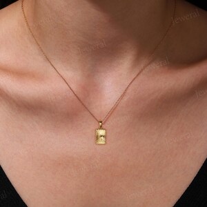 a close up of a woman wearing a necklace