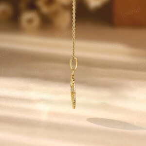 a close up of a gold necklace on a table