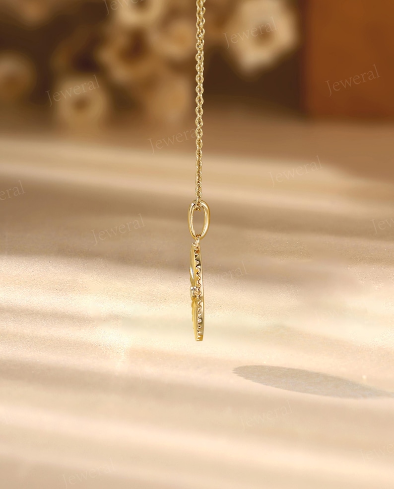 a close up of a gold necklace on a table