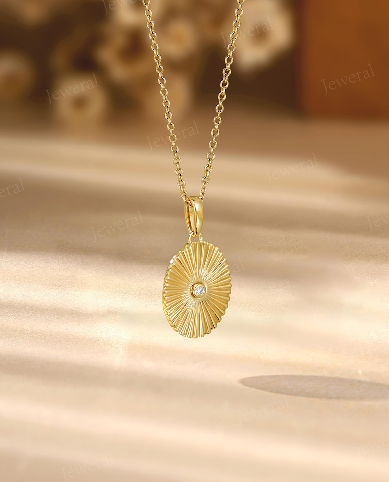 a gold necklace with a diamond in the center