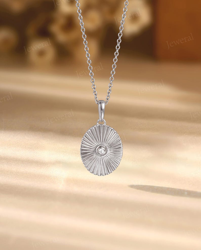 a silver necklace with a diamond in the center