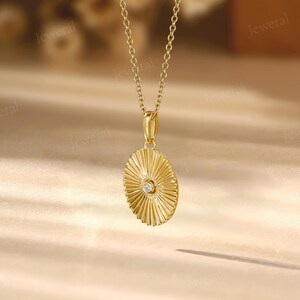 a gold necklace with a diamond in the center