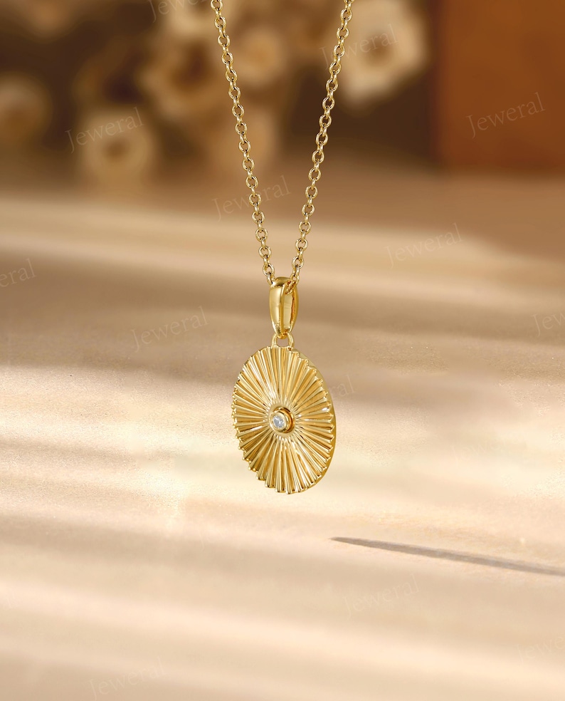 a gold necklace with a diamond in the center