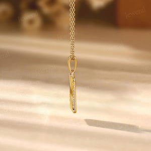 a gold necklace with a long chain hanging from it