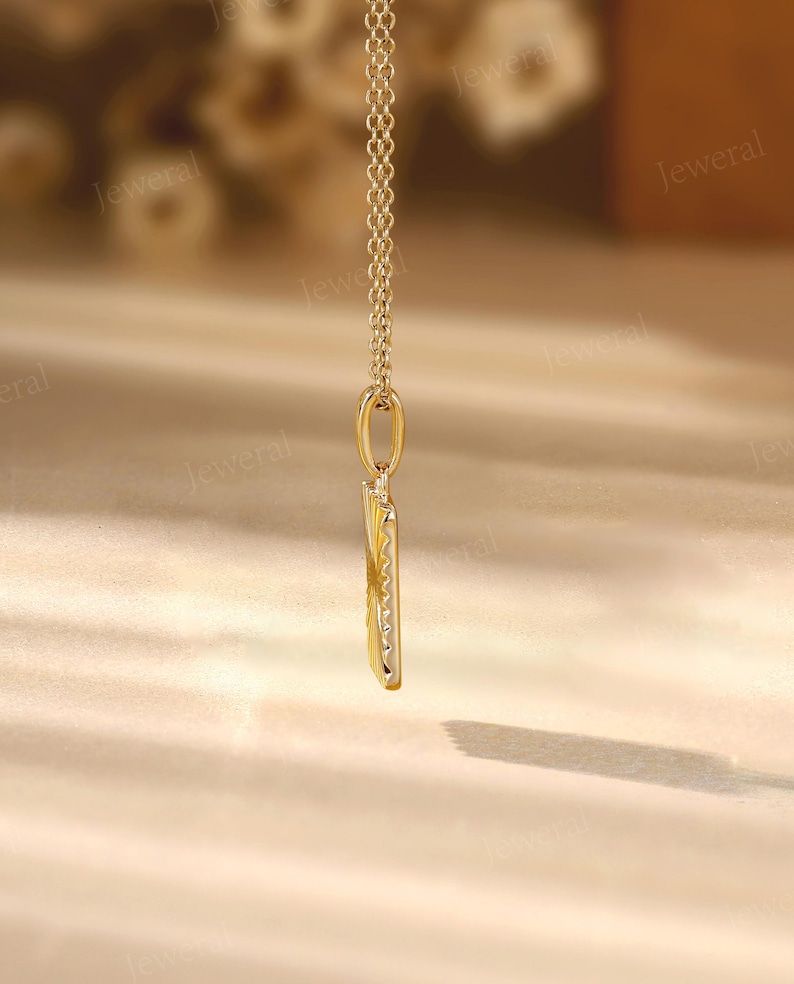 a gold necklace with a long chain hanging from it