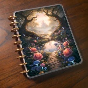 May include: A planner with a fantasy landscape cover featuring a path leading to a castle, surrounded by pink roses, blue mushrooms, and a serene pond. The planner has gold-colored disc binding.