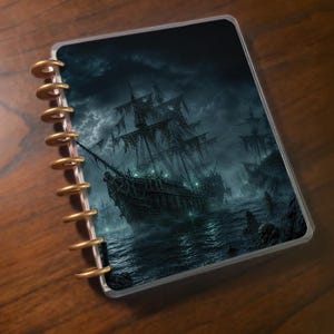 May include: A disc-bound notebook featuring a dark, atmospheric cover illustration of a ghost ship sailing on turbulent, stormy waters at night. The cover displays a detailed, weathered sailing vessel with tattered sails and glowing green accents.