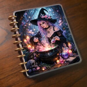 May include: A spiral-bound notebook featuring a fantasy illustration of a witch in a black dress and hat, brewing a potion in a cauldron. The image includes candles, a skull, and potion bottles, with a mystical forest background.