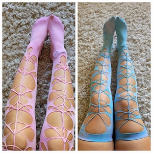 May include: Two pairs of thigh-high stockings with a lace-like pattern. One pair is pink and the other is blue.