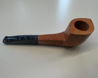 May include: A brown wooden pipe with a black and white mottled mouthpiece.