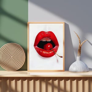 Puede incluir: Un primer plano de una pintura que representa un par de labios rojos mordiendo una cereza roja brillante con un tallo verde.