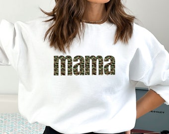 May include: White sweatshirt with the word "mama" printed in a camouflage pattern.