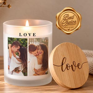 May include: A frosted glass candle with a lit wick, featuring the word LOVE and two printed photographs of a couple embracing. A round wooden lid with the word love in cursive script sits beside it, and a gold Best Choice seal is visible.