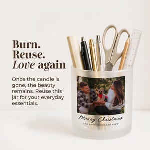 May include: A frosted glass jar filled with pens, a pencil, scissors, and a ruler. The jar features a custom photo of a couple with a dog and the text "Merry Christmas" and "ADD YOUR PHOTO AND TEXT". Text on the left reads "Burn. Reuse. Love again".