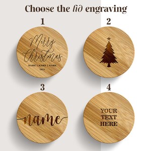 May include: Four circular bamboo lids with engraved designs. Option 1 features 'Merry Christmas' with space for names and '2025'. Option 2 shows a Christmas tree. Option 3 displays 'name' in script. Option 4 reads 'YOUR TEXT HERE'. Text reads 'Choose the lid engraving'.