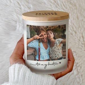 May include: A white candle with a wooden lid, featuring a photo of two smiling women. The lid is engraved with "FRIENDS FOREVER." Below the photo, the text reads "to my bestie" with a heart symbol.
