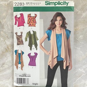 May include: A Simplicity sewing pattern envelope 2283, size H5 6, 8, 10, 12, 14. The front displays illustrations of various tops and vests, including a beige open-front vest worn over a blue top and black pants, with a barcode and text at the bottom.