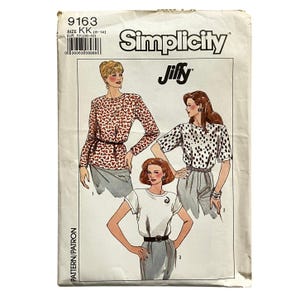 May include: A Simplicity Jiffy sewing pattern envelope, number 9163, size KK (8-14). The front features illustrations of three different tops: one with a red heart print, one with a black polka dot print, and one solid white top with a spiral detail.