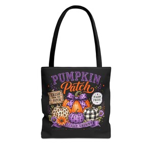 May include: A black tote bag featuring a graphic print of pumpkins with various patterns including leopard print, plaid, and purple stars. The text reads PUMPKIN PATCH, FRESH FROM THE PATCH, FARM FRESH, and LOCALLY GROWN with floral accents.