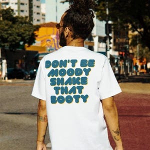 Funny Graphic Tee - ‘Don’t Be Moody, Shake That Booty’ - graphic GIF - meme shirt
