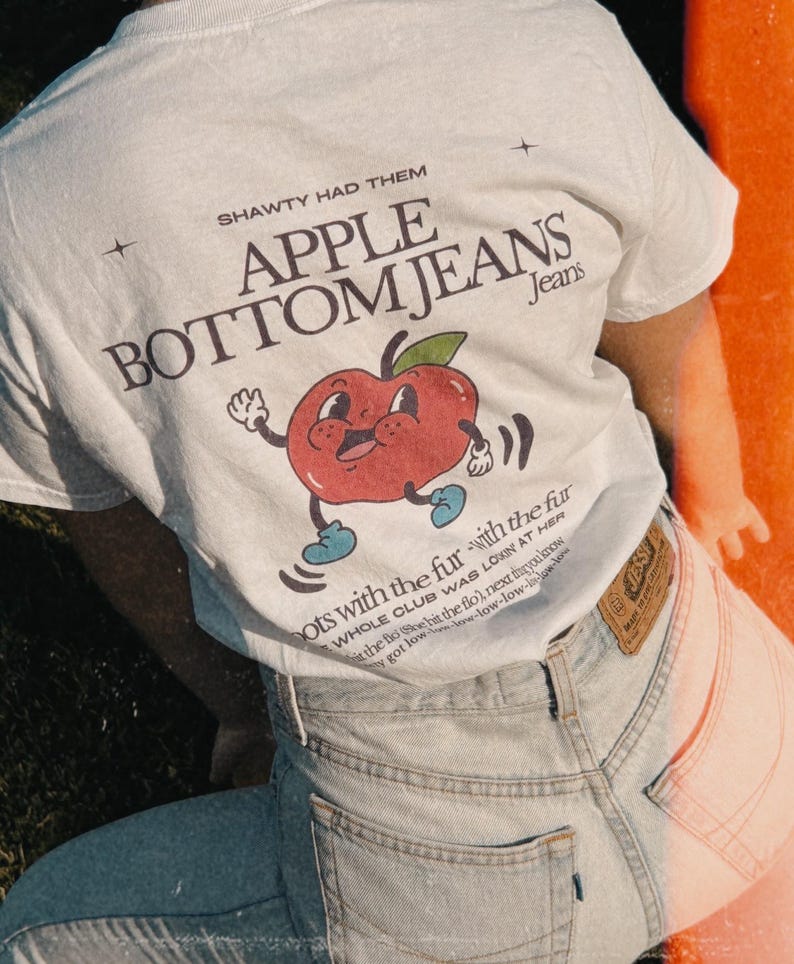 White unisex cotton t-shirt with a quirky fruit design and Flo Rida’s iconic “Low” lyrics on the back