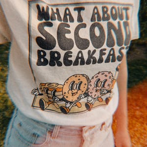 Funny Lord of the Rings-inspired “Second Breakfast” shirt with a quirky breakfast theme and retro-style food graphic.