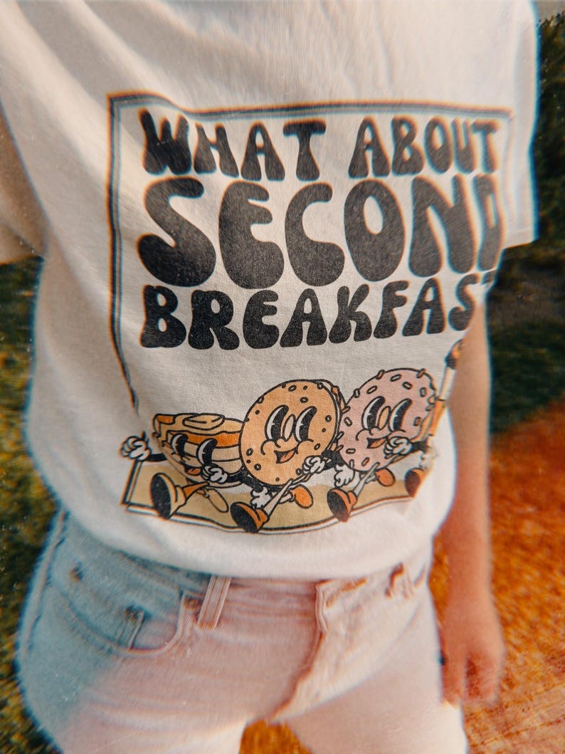 Funny Lord of the Rings-inspired “Second Breakfast” shirt with a quirky breakfast theme and retro-style food graphic.