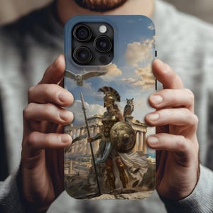 May include: Blue phone case featuring a detailed illustration of a classical warrior with a spear and shield, set against a backdrop of ancient architecture and a cloudy sky. An owl is perched on the warrior's shoulder and another is flying above.