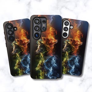 May include: Three smartphone cases featuring a vertical arrangement of wolf heads surrounded by swirling smoke and flames in vibrant shades of orange, yellow, green, and blue against a dark background, with visible camera lens cutouts on the back.