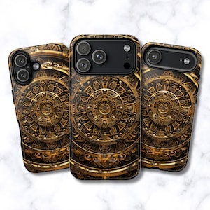 May include: Three phone cases featuring a detailed, golden Aztec calendar design. The cases are dark brown with intricate patterns and a metallic gold finish. The cases have camera cutouts and are displayed on a white marble surface.