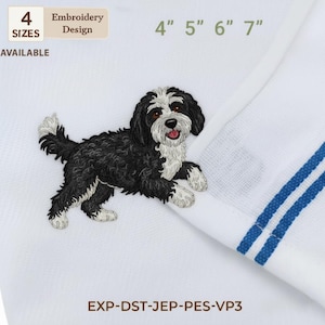May include: White towel with a black and white embroidered dog design. The towel has blue stripes and the text "4 SIZES AVAILABLE". The embroidery design is available in 4", 5", 6", and 7" sizes.