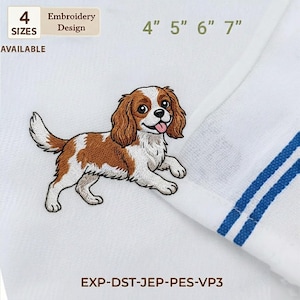 May include: White towel with a detailed embroidery design of a Cavalier King Charles Spaniel dog in brown, white, and tan. The sizes available are 4", 5", 6", and 7". The towel has blue stripes.