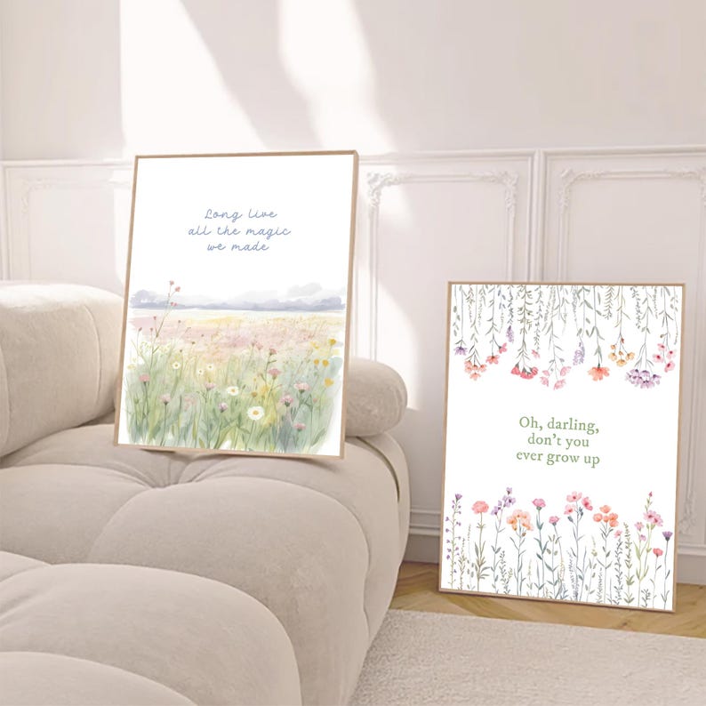 May include: Two framed art prints with floral and landscape watercolor designs. One print features a field of wildflowers with the text "Long live all the magic we made." The other print has hanging flowers and the text "Oh, darling, don't you ever grow up."