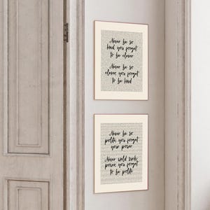 May include: Two framed art prints with inspirational quotes in black script on a cream background. The top print reads "Never be so kind, you forget to be clever. Never be so clever, you forget to be kind." The bottom print reads "Never be so polite, you forget your power. Never weld such power, you forget to be polite."