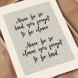 May include: A cream-coloured print featuring the words "Never be so kind, you forget to be clever. Never be so clever, you forget to be kind." The text is in black, handwritten-style lettering.