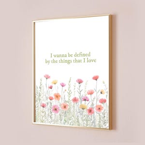 May include: A printable art print with a watercolor illustration of a field of pink, orange, and yellow flowers. The print features the quote "I wanna be defined by the things that I love."
