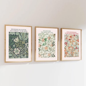 May include: Three framed prints featuring floral patterns and inspirational quotes. The first print has a green and blue floral pattern with the quote "Never be so clever, you forget to be kind". The second print has a white and green floral pattern with the quote "To live for the hope of it all". The third print has a red, orange, and blue floral pattern with the quote "If you never bleed, you're never gonna grow".