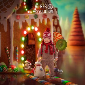 May include: A child in a brown outfit, red hat, and scarf stands in a whimsical Christmas scene. A gingerbread house with colorful lights and candy decorations is in the background. A snowman and a puppy are also present.