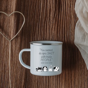 May include: A light blue enamel mug with a silver rim and handle. The mug features the text "You cannot do epic SHIT with basic PEOPLE" and a row of cartoon animals. The words "DESERT BLACK COFFEE" are below the text.