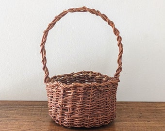 Rustic vintage willow wicker basket with tall twisted handle