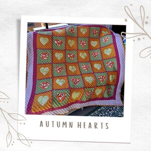 May include: A crocheted quilt with a patchwork design featuring hearts in shades of green, orange, and pink. The quilt is labelled "AUTUMN HEARTS".